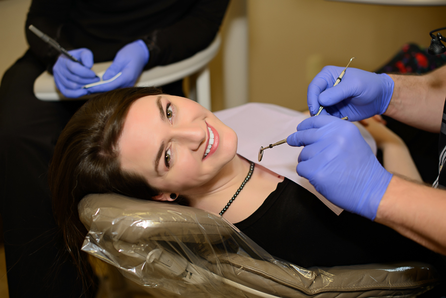 Woman getting ready for her zoom teeth whitening treatment at Woodland Family Dental. 