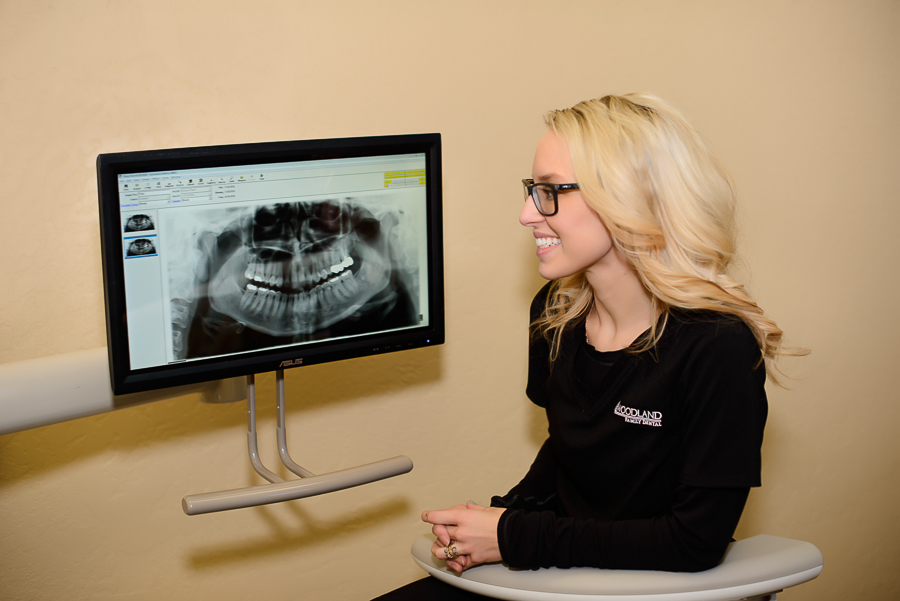 Angie is reviewing some x-rays to see what restorative dentistry options are available to a recent patient at Woodland Family Dental. 
